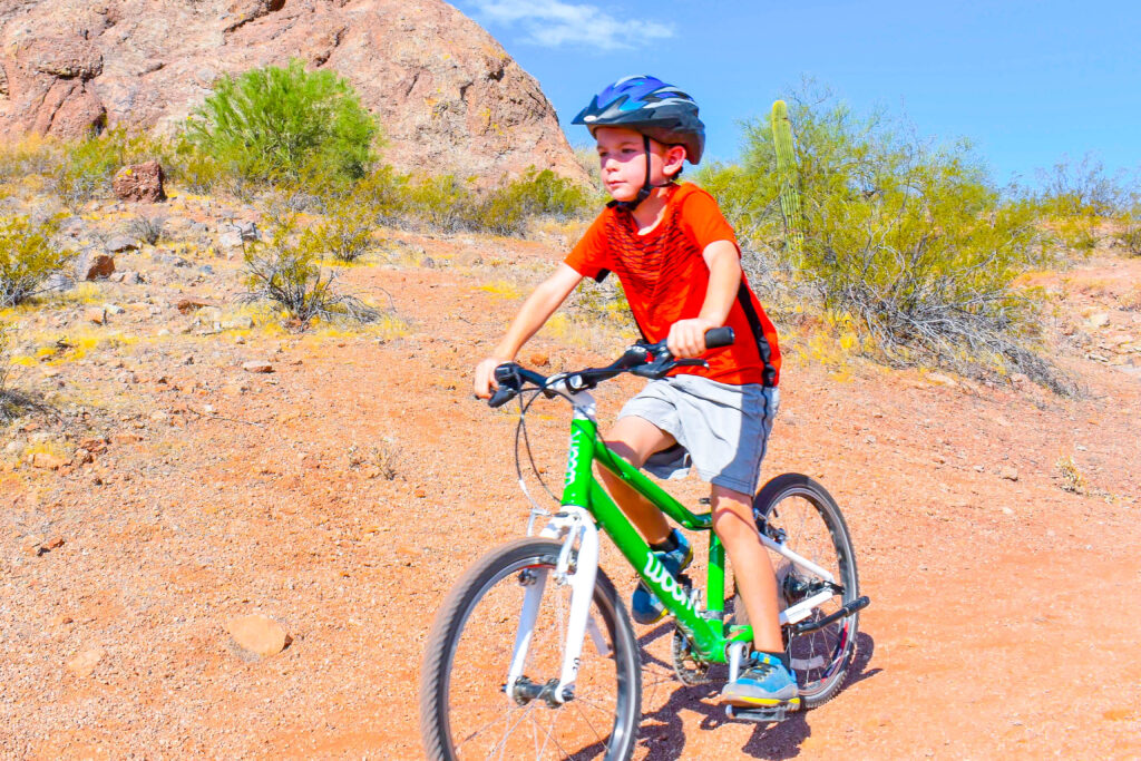 boy mountain biking arizona with a woom mountain bike for kids