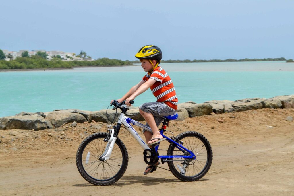 boy riding bike beach